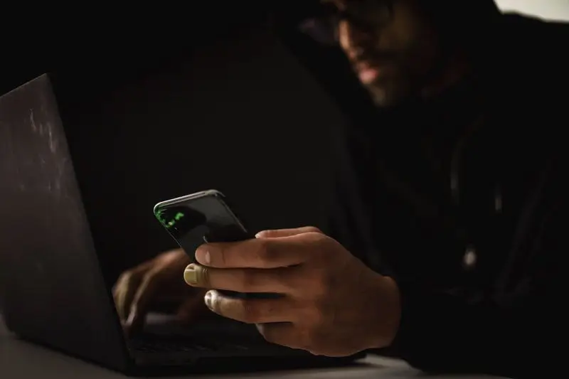 Man Using Phone and Computer_AutoRABIT