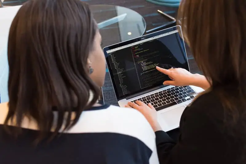 Two people coding on a computer_AutoRABIT