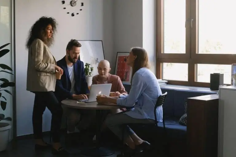 People talking around a computer_AutoRABIT